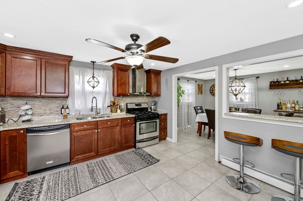 36 Hally Road Lowell, MA 01854 - Photo 10 of 33 a kitchen with stainless steel appliances granite countertop a sink and cabinets
