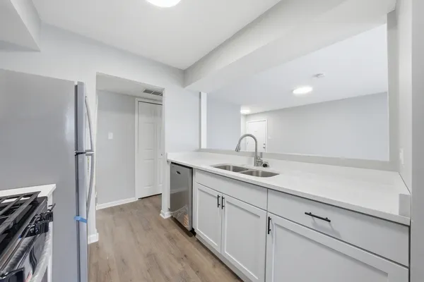 a kitchen with a sink and a refrigerator