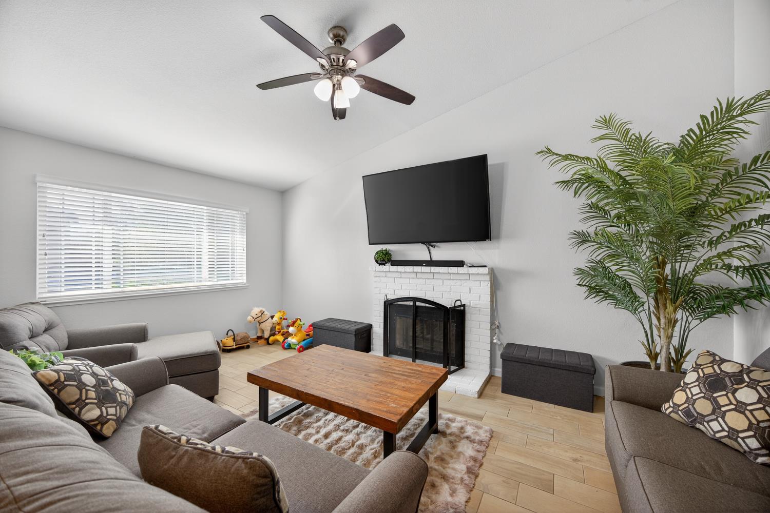 3237 Oriole Way Antelope, CA 95843 - Photo 11 of 47 a living room with furniture a fireplace and a flat screen tv