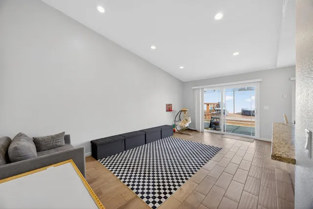 a bathroom with a granite countertop toilet sink and mirror