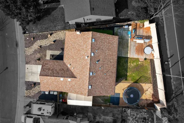 an aerial view of a house with a yard