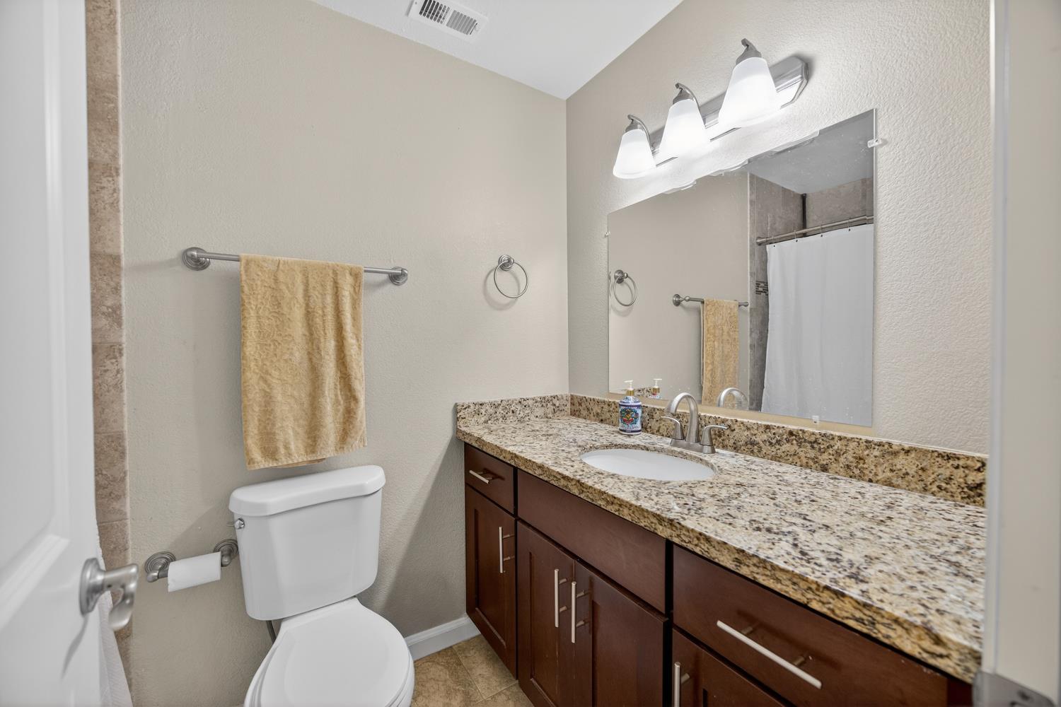 3237 Oriole Way Antelope, CA 95843 - Photo 24 of 47 a bathroom with a granite countertop toilet sink and mirror