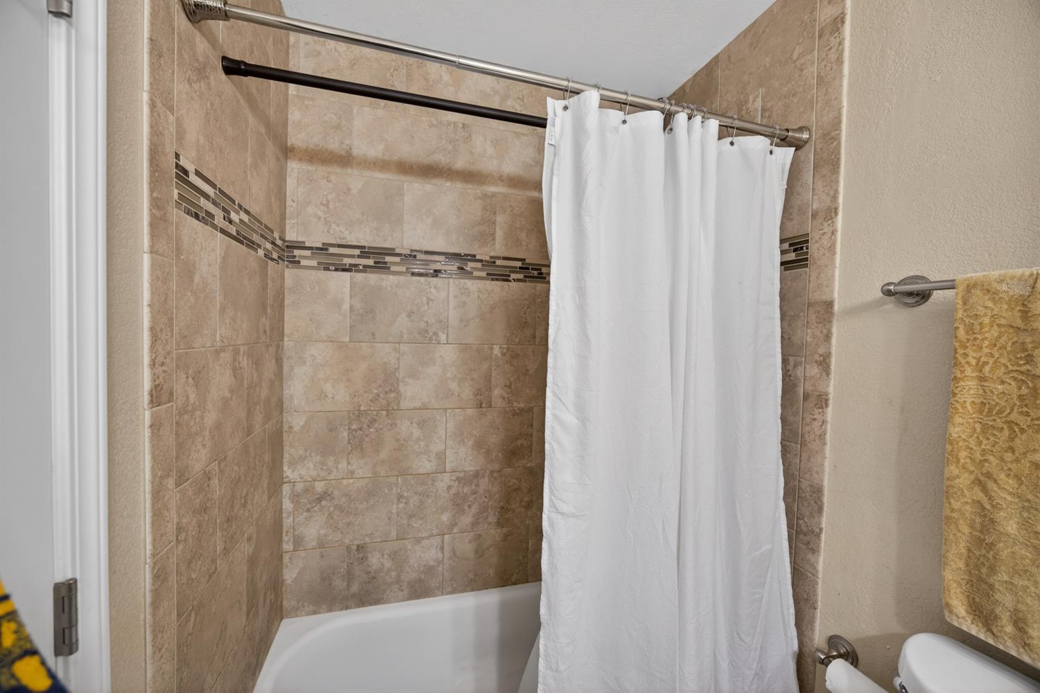 3237 Oriole Way Antelope, CA 95843 - Photo 25 of 47 a bathroom with a shower curtain and a toilet sink