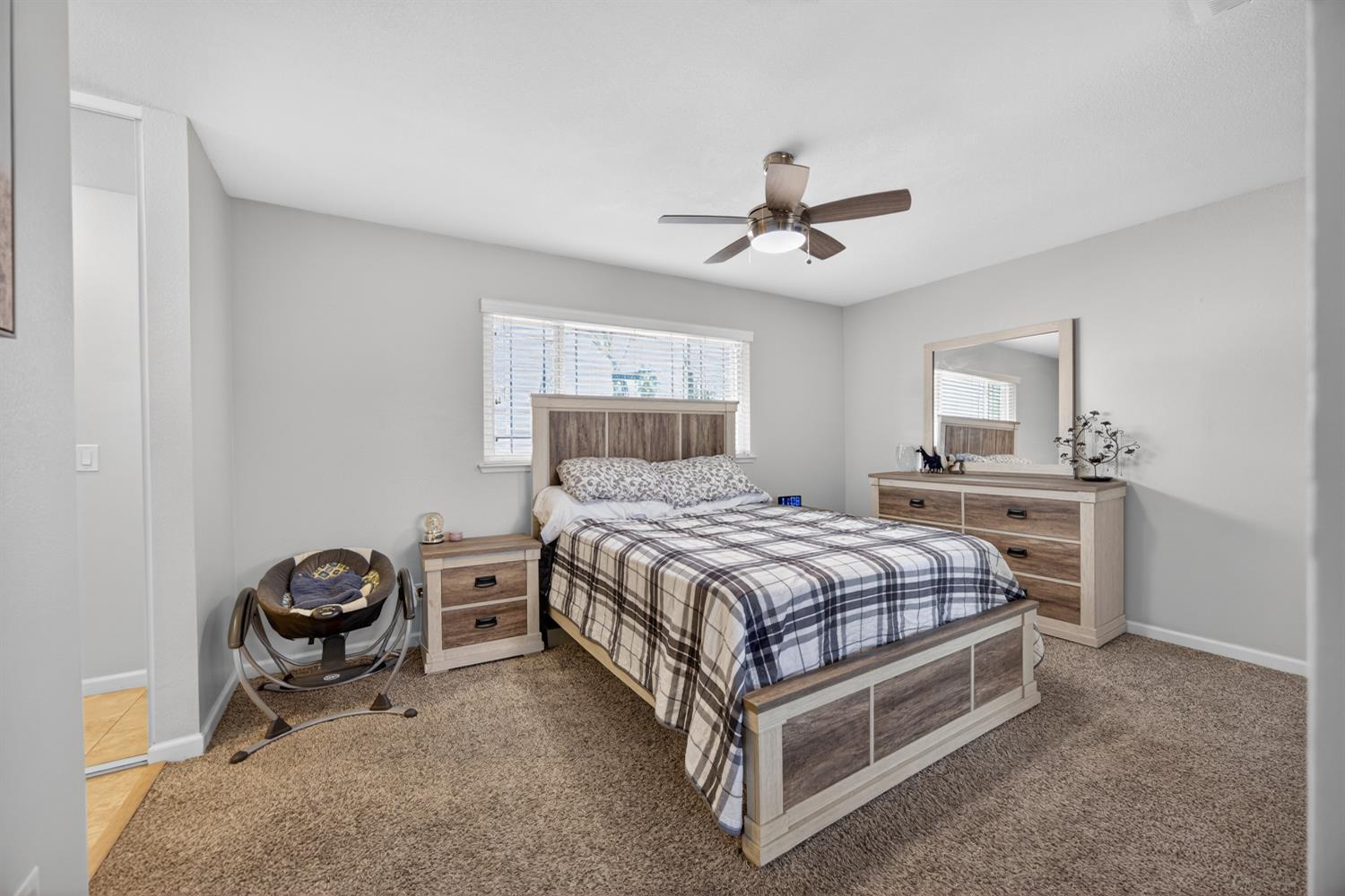 3237 Oriole Way Antelope, CA 95843 - Photo 28 of 47 a bedroom with a bed and a chandelier