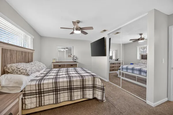 a bedroom with a large bed and a tv