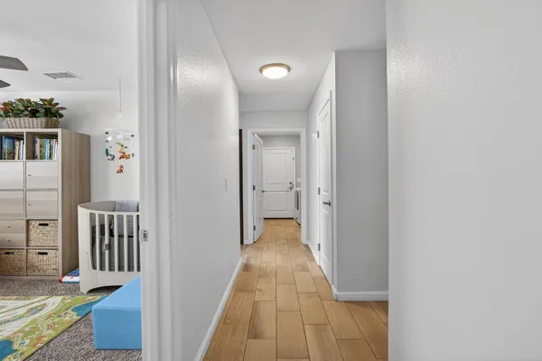 a view of a hallway with wooden floor