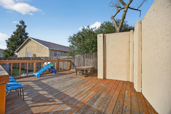 a backyard of a house with table and chairs