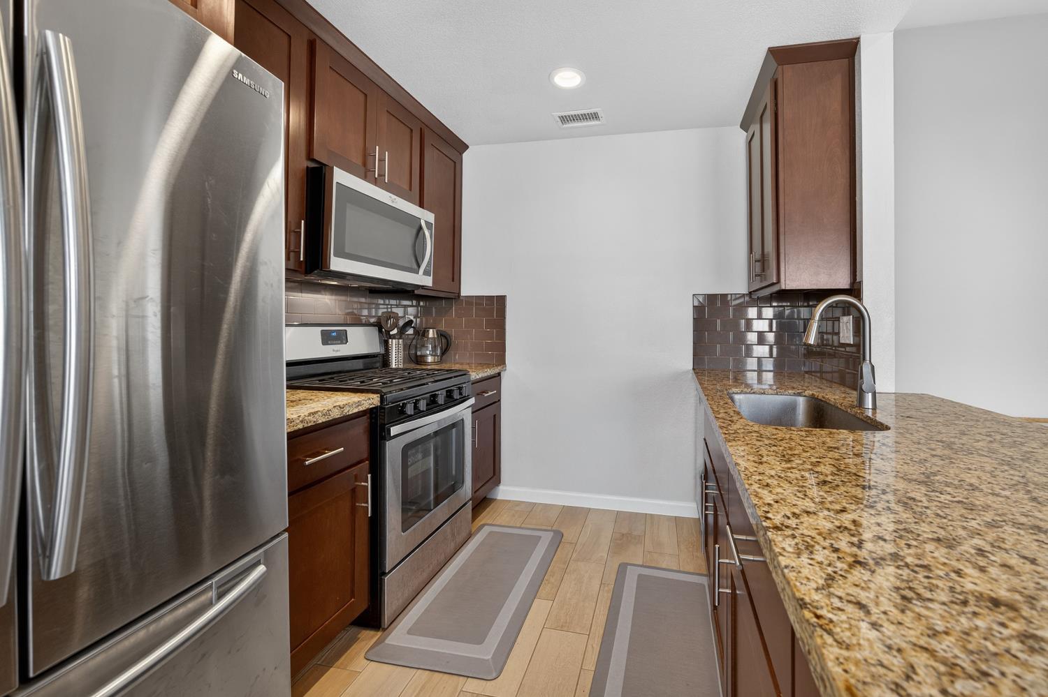 3237 Oriole Way Antelope, CA 95843 - Photo 5 of 47 a kitchen with stainless steel appliances granite countertop a refrigerator and a stove