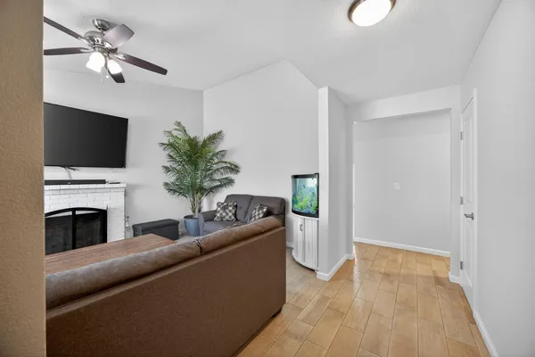 a living room with furniture a fireplace and a flat screen tv