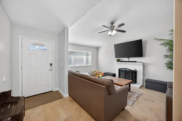 a living room with furniture a fireplace and a flat screen tv