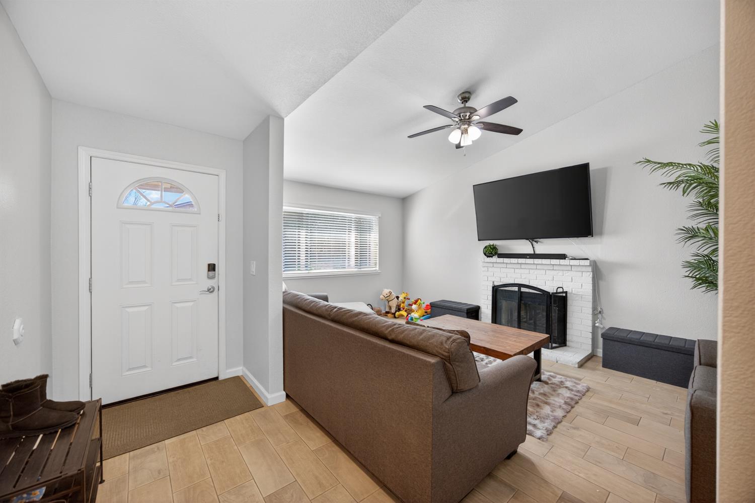 3237 Oriole Way Antelope, CA 95843 - Photo 10 of 47 a living room with furniture a fireplace and a flat screen tv