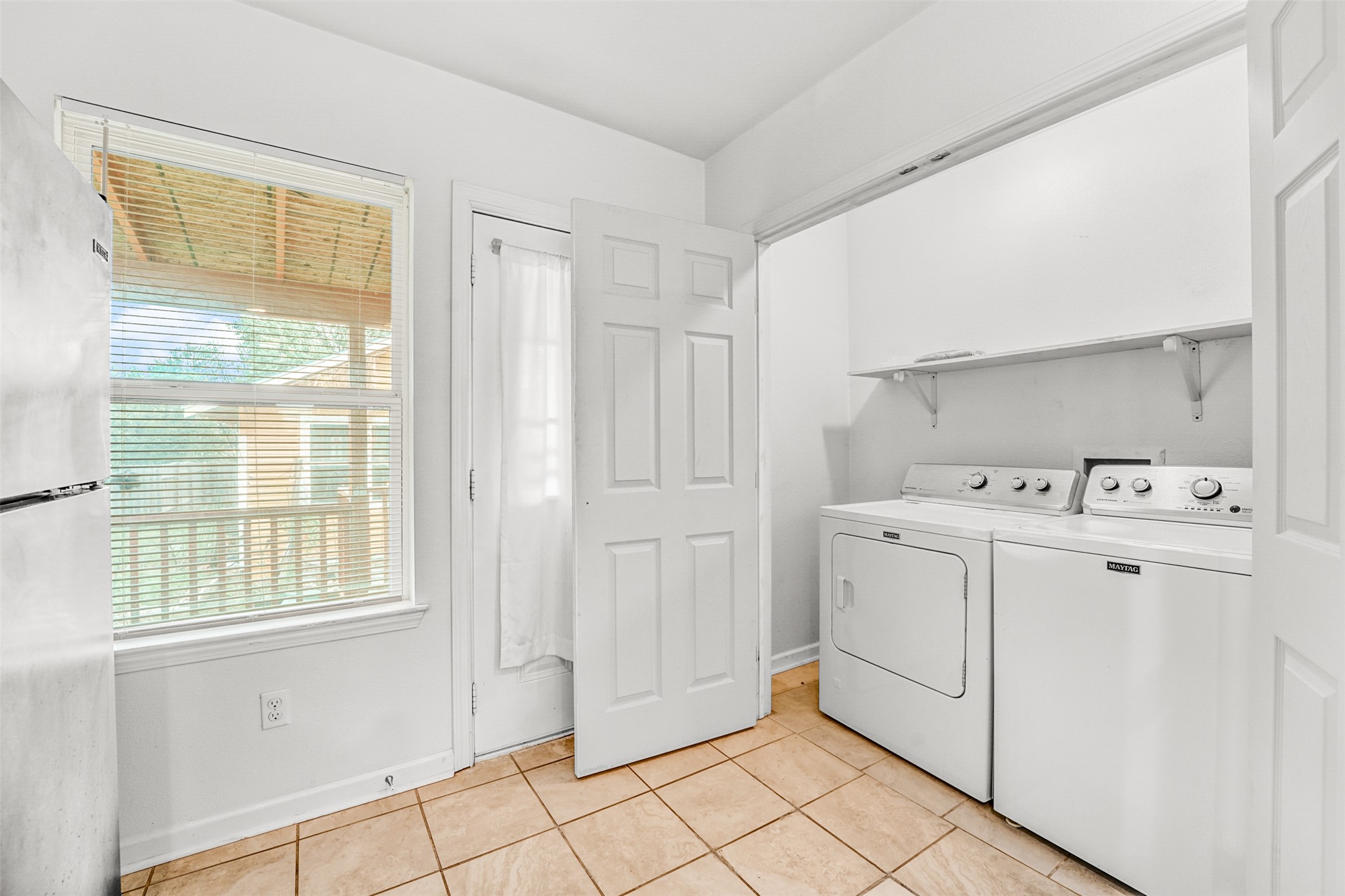 6906 Carver Avenue, Unit A Austin, TX 78752 - Photo 18 of 24 Laundry area featuring light tile patterned floors and separate washer and dryer