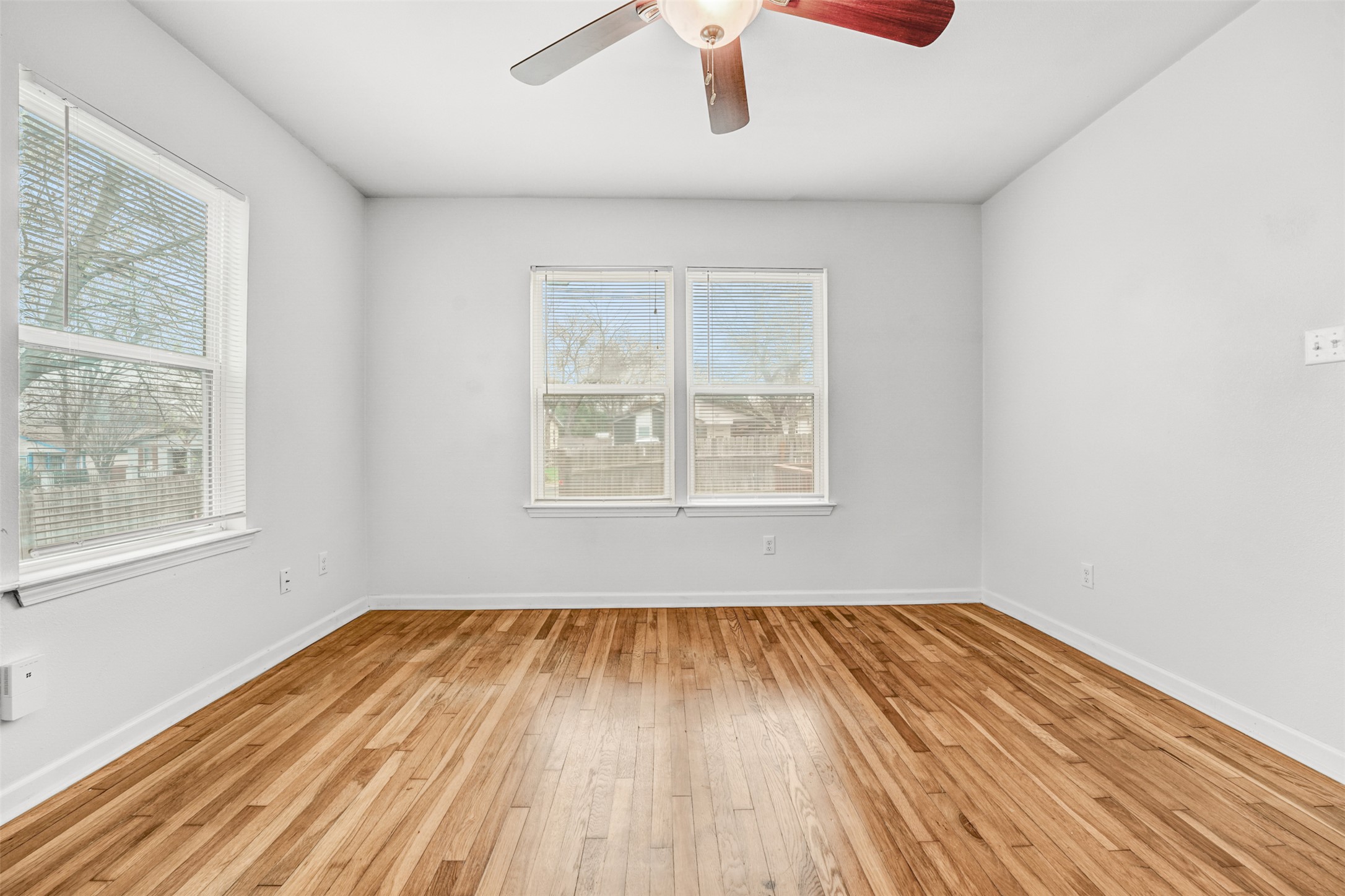 6906 Carver Avenue, Unit A Austin, TX 78752 - Photo 19 of 24 Empty room featuring light wood-type flooring and ceiling fan