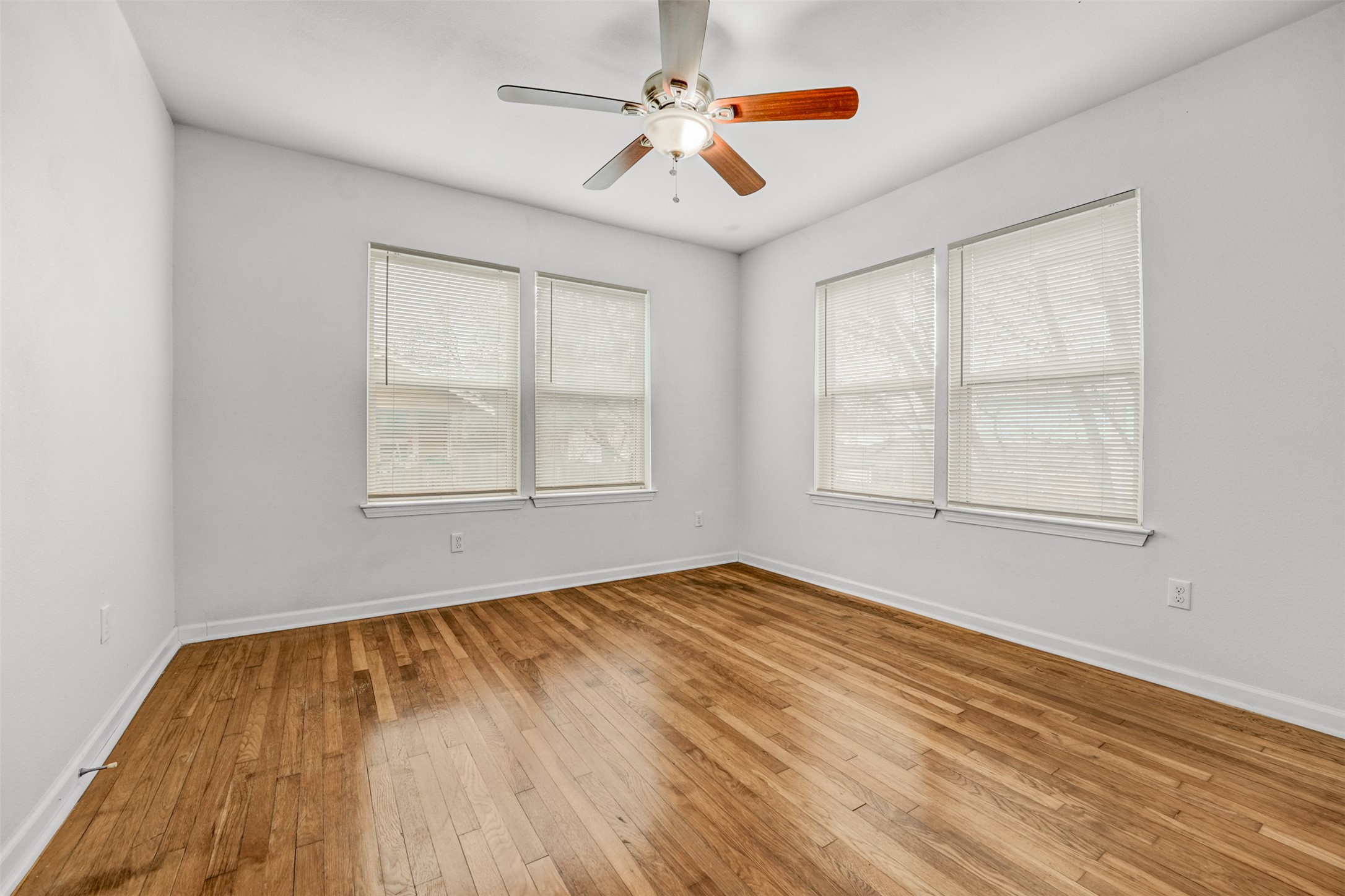 6906 Carver Avenue, Unit A Austin, TX 78752 - Photo 21 of 24 Unfurnished room featuring light wood-type flooring, a ceiling fan, and healthy amount of natural light