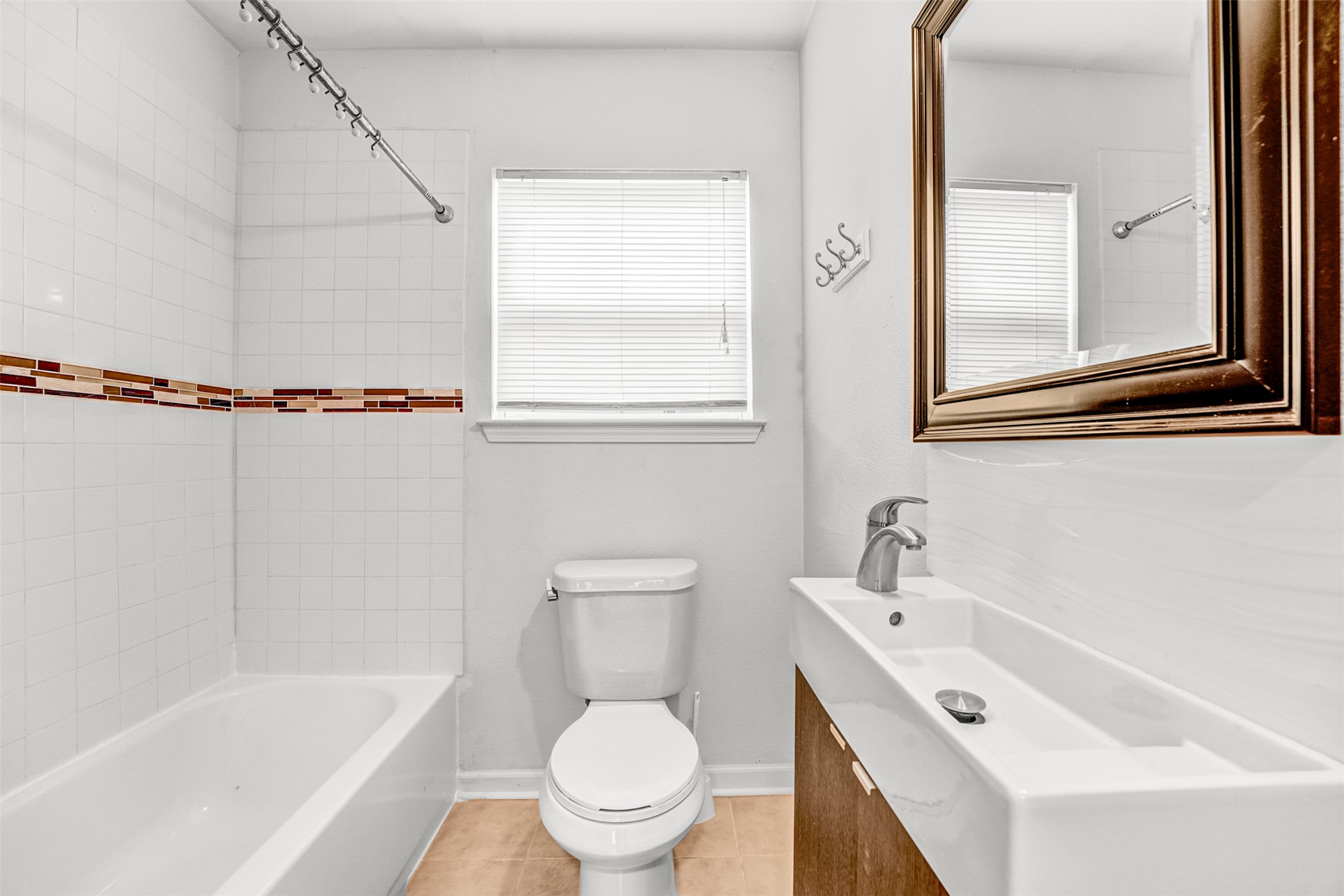 6906 Carver Avenue, Unit A Austin, TX 78752 - Photo 23 of 24 Bathroom featuring vanity, light tile patterned floors, and shower / washtub combination
