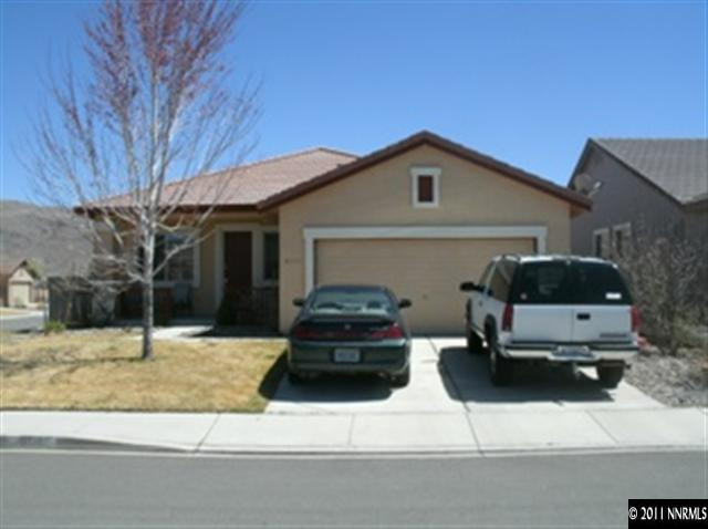 9718 Thunder Mountain Way Reno, NV 89521 - Photo 1 of 1 a car parked in front of a house