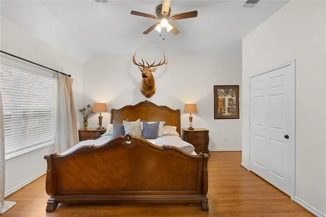 a bed sitting in a bedroom next to a window