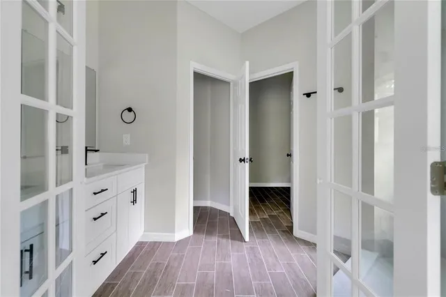 a view of walk in closet with wooden floor