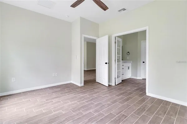 an empty room with wooden floor and closet