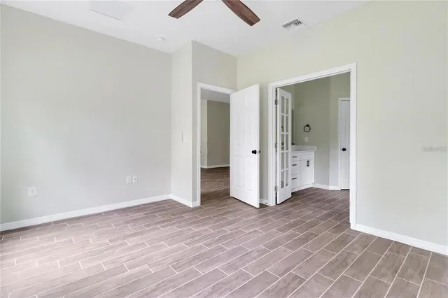 an empty room with wooden floor and closet