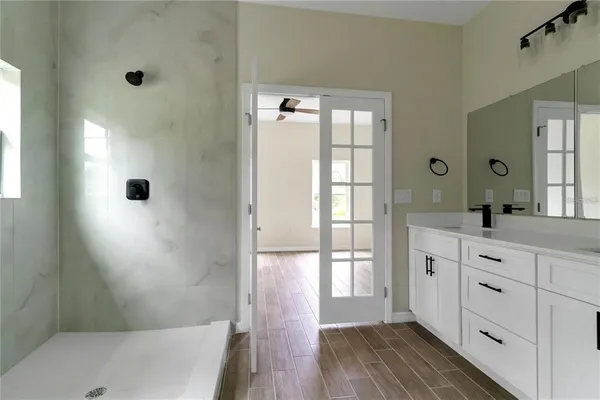 a bathroom with a tub a sink and mirrors