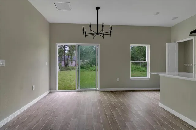 a view of a room with window wooden floor and windows