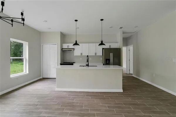a view of a living room with a fireplace and windows