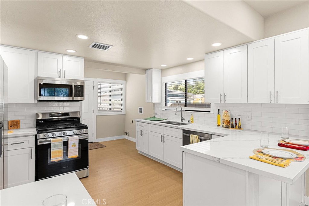 2855 Mulberry Street Riverside, CA 92501 - Photo 14 of 43 a kitchen with stainless steel appliances a stove sink microwave and cabinets