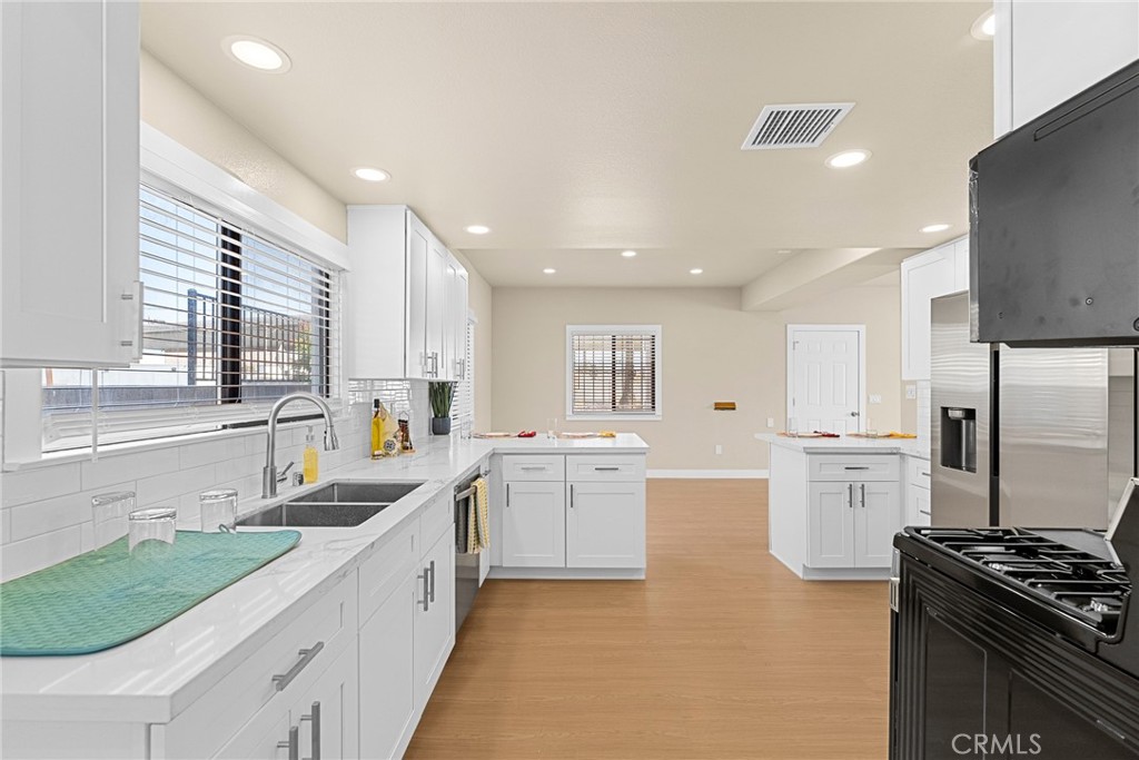 2855 Mulberry Street Riverside, CA 92501 - Photo 16 of 43 a kitchen with a sink stove top oven and refrigerator