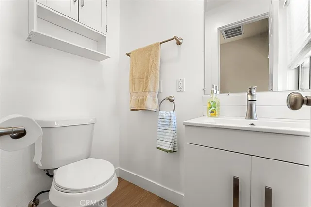 a bathroom with a sink toilet and mirror