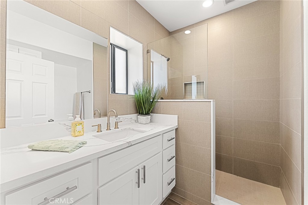 2855 Mulberry Street Riverside, CA 92501 - Photo 22 of 43 a bathroom with a granite countertop sink and a mirror