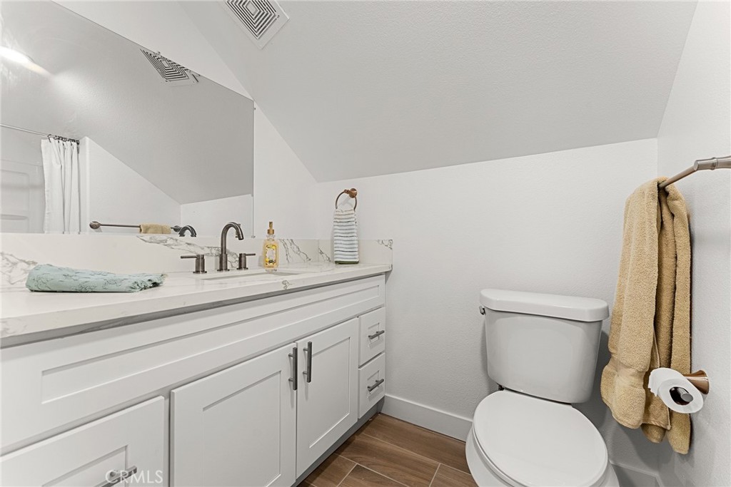 2855 Mulberry Street Riverside, CA 92501 - Photo 30 of 43 a bathroom with a toilet sink and mirror
