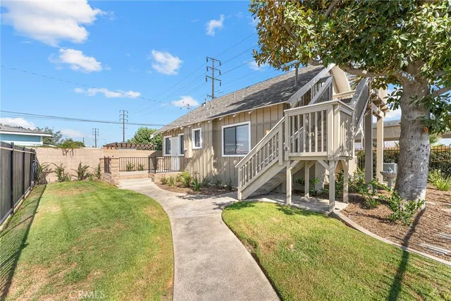 a view of a brick house with a wooden fence