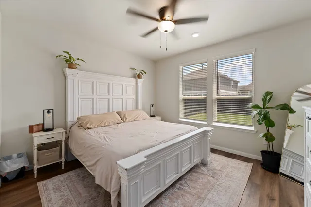 a bedroom with a bed table and a window