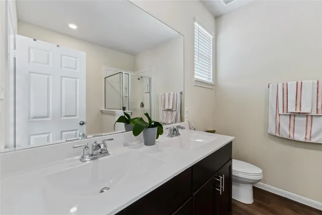 a bathroom with a sink a toilet and mirror