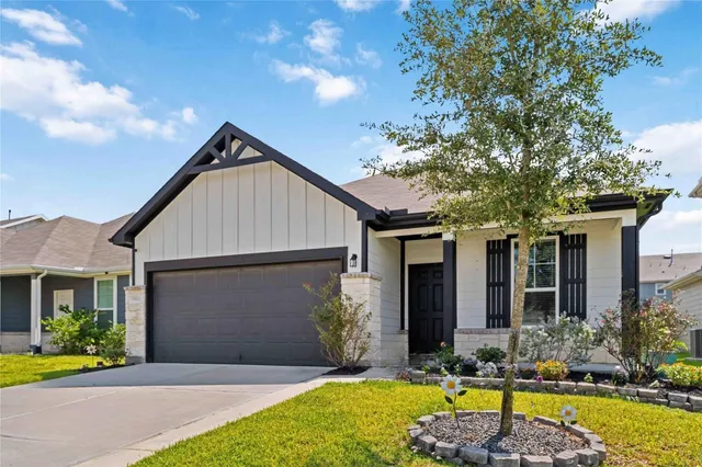 a front view of a house with swimming pool and porch with furniture