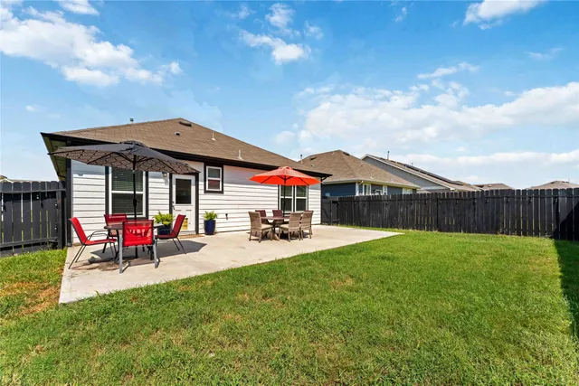 a house view with a sitting space and garden