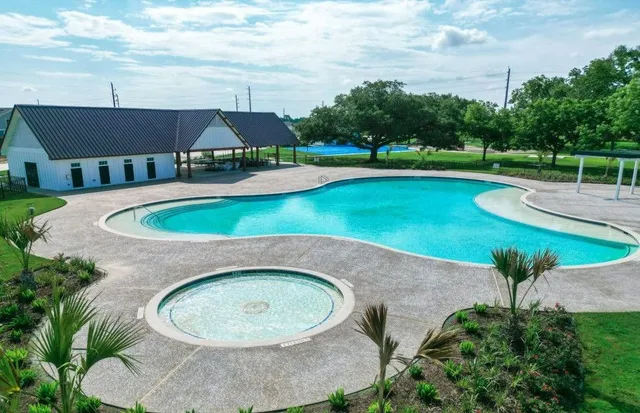 an aerial view of a house with swimming pool and garden