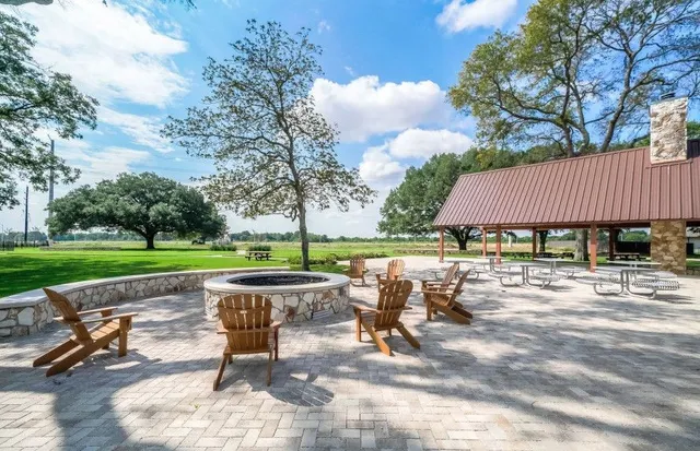 a view of a patio with a table chairs and a yard