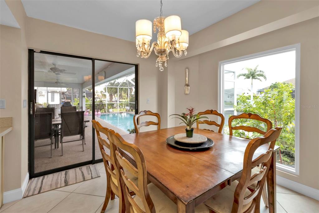 820 Bal Harbor Boulevard Punta Gorda, FL 33950 - Photo 14 of 56 a dining room with furniture a large window and a chandelier