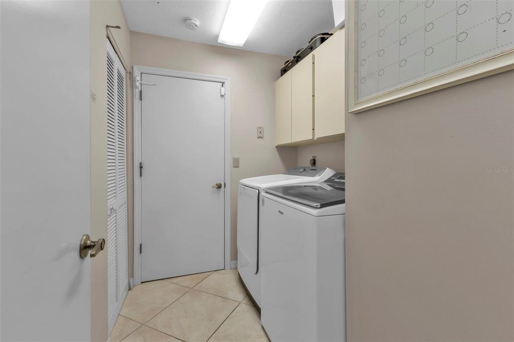 820 Bal Harbor Boulevard Punta Gorda, FL 33950 - Photo 33 of 56 a utility room with cabinets washer and dryer