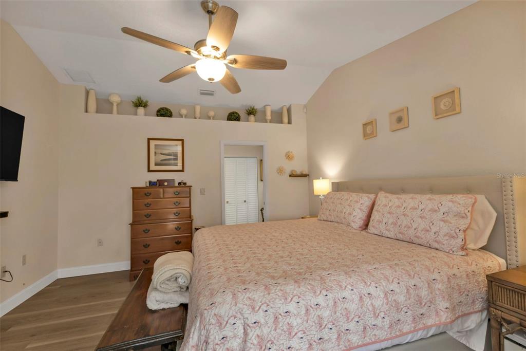 820 Bal Harbor Boulevard Punta Gorda, FL 33950 - Photo 36 of 56 a bedroom with a bed and a chandelier