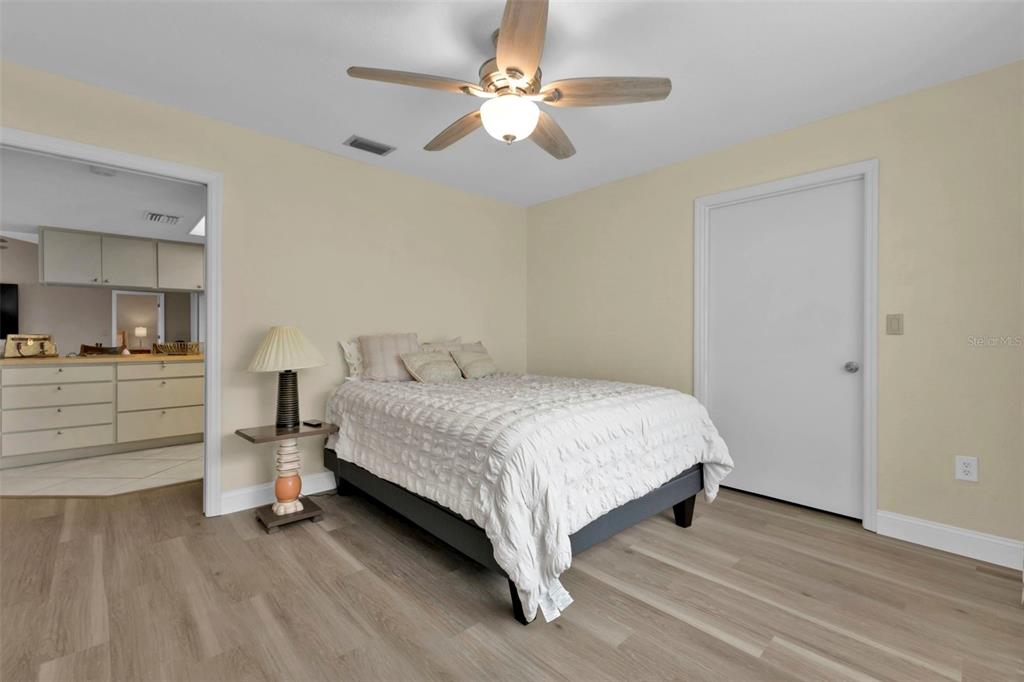 820 Bal Harbor Boulevard Punta Gorda, FL 33950 - Photo 42 of 56 a bedroom with a bed and a chandelier