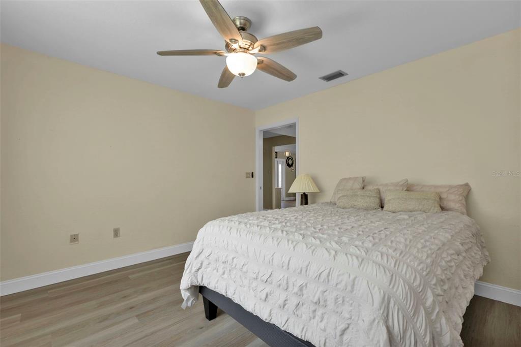 820 Bal Harbor Boulevard Punta Gorda, FL 33950 - Photo 44 of 56 a bedroom with a bed and a ceiling fan