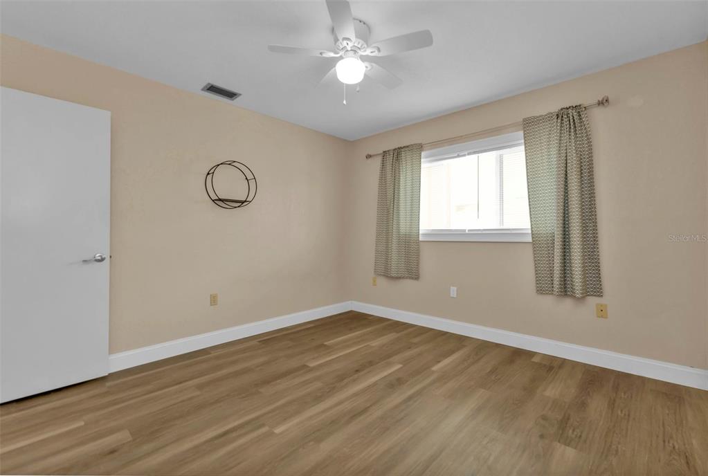 820 Bal Harbor Boulevard Punta Gorda, FL 33950 - Photo 47 of 56 an empty room with wooden floor and windows
