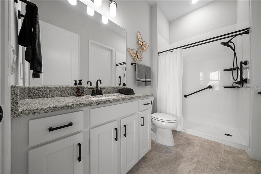 8750 Southwest 59th Ln Road Ocala, FL 34481 - Photo 11 of 41 a bathroom with a granite countertop sink toilet and shower