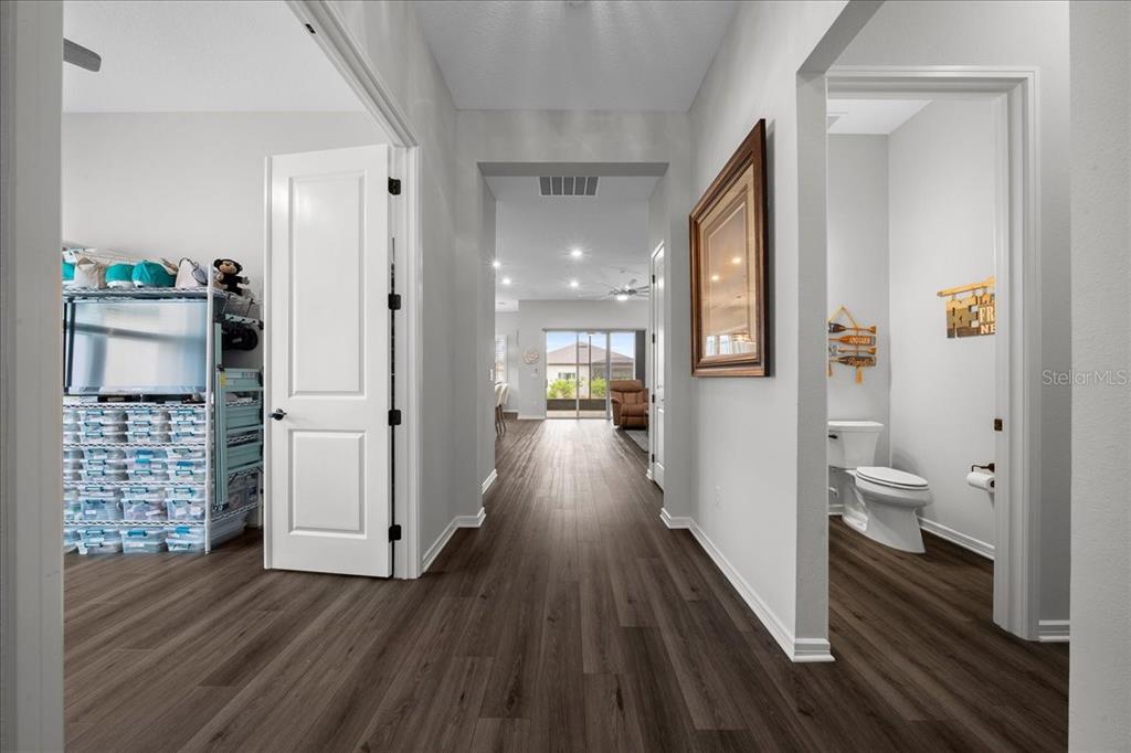 8750 Southwest 59th Ln Road Ocala, FL 34481 - Photo 13 of 41 a view of a hallway with wooden floor and a living room