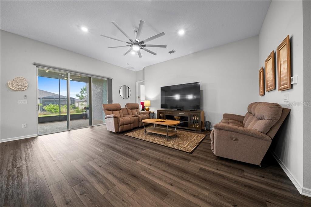 8750 Southwest 59th Ln Road Ocala, FL 34481 - Photo 19 of 41 a living room with furniture and a flat screen tv