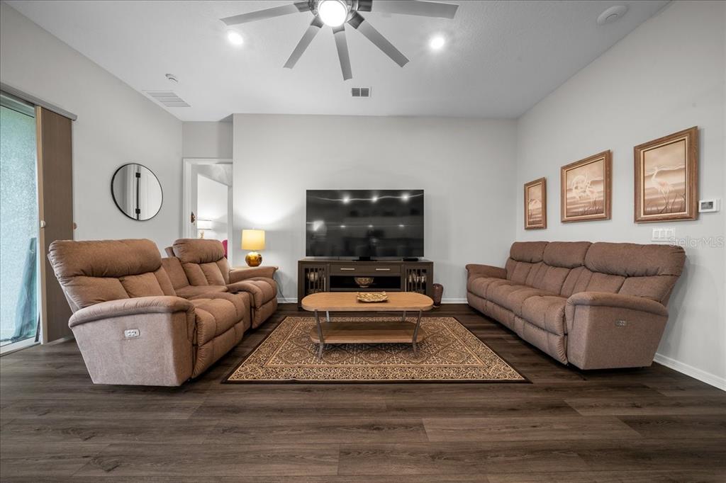8750 Southwest 59th Ln Road Ocala, FL 34481 - Photo 20 of 41 a living room with furniture and a flat screen tv