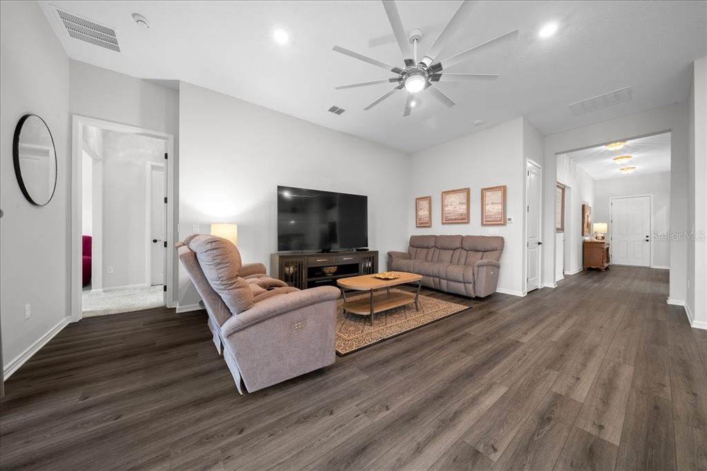 8750 Southwest 59th Ln Road Ocala, FL 34481 - Photo 21 of 41 a living room with furniture and a flat screen tv